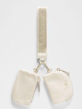 Lululemon Dual Pouch Wristlet Metallic Wordmark Faint Light Ivory & Gold